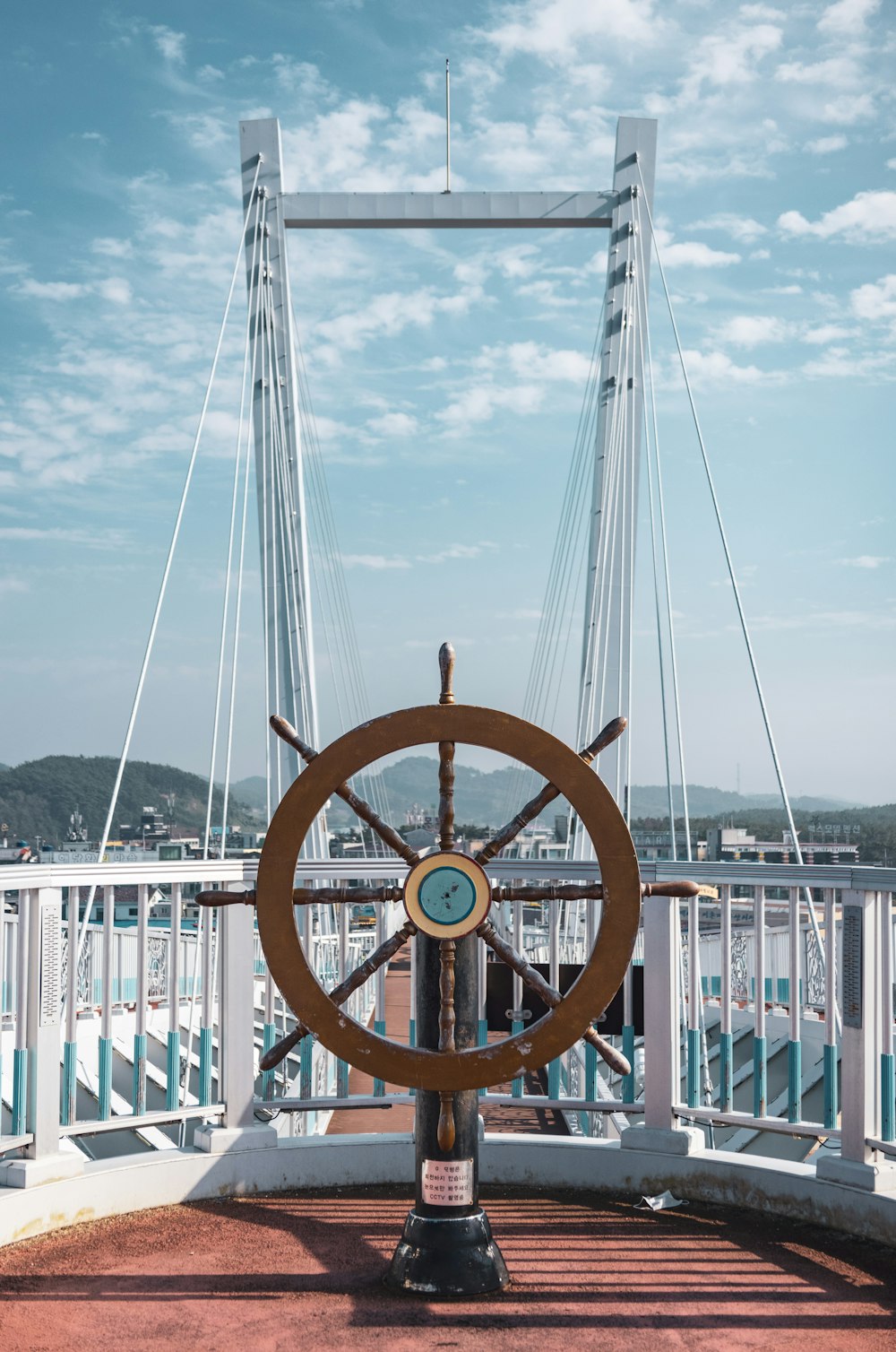 a large metal wheel on a dock