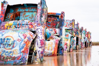 a group of people standing next to a large colorful sculpture