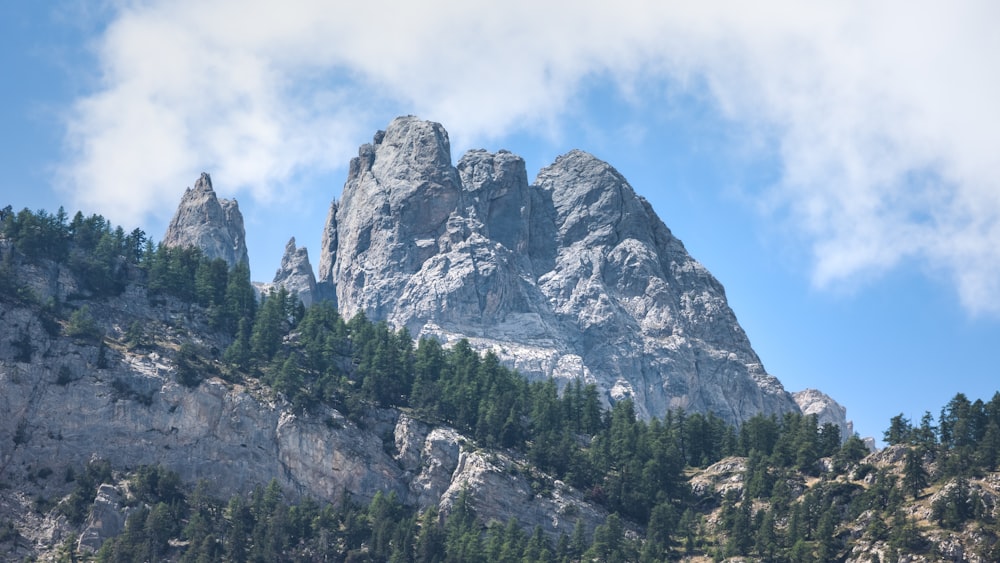 a mountain with trees and clouds