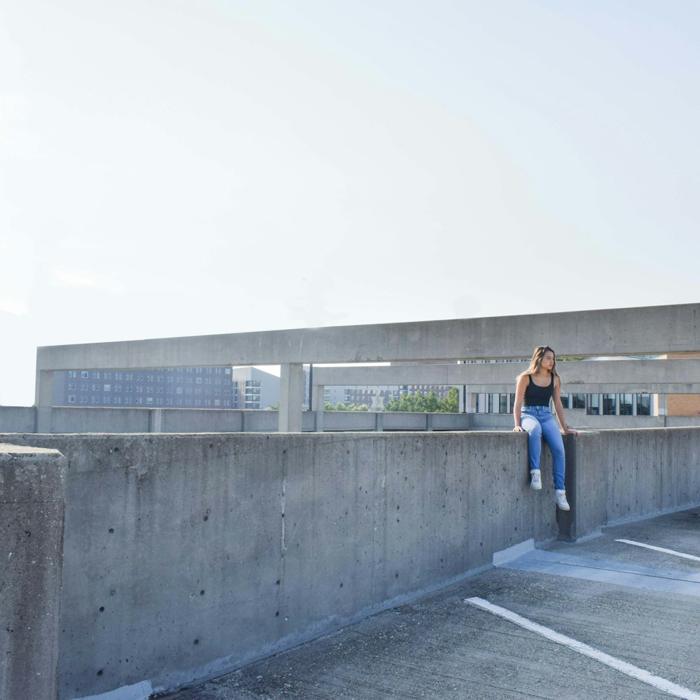 a man standing on a concrete wall