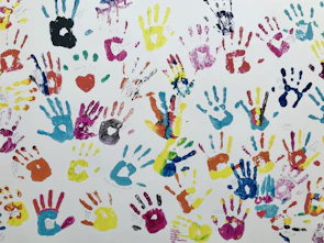 Close-up of colorful handprints on paper from a creative therapy session