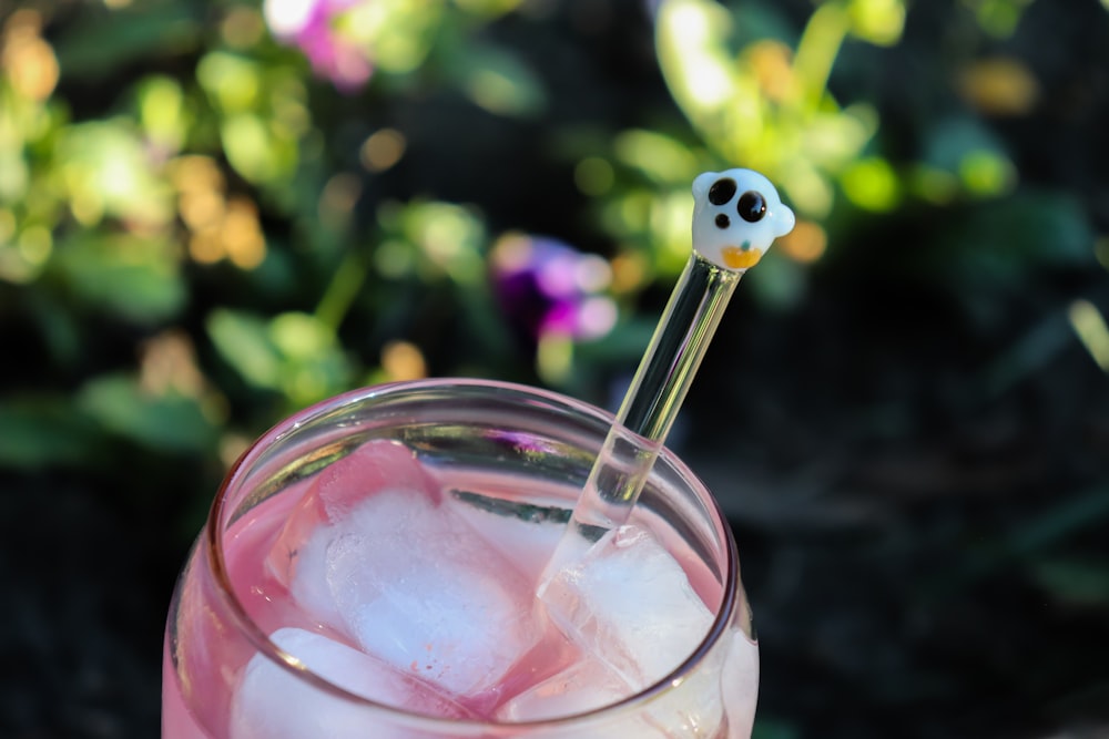 a bird drinking from a glass