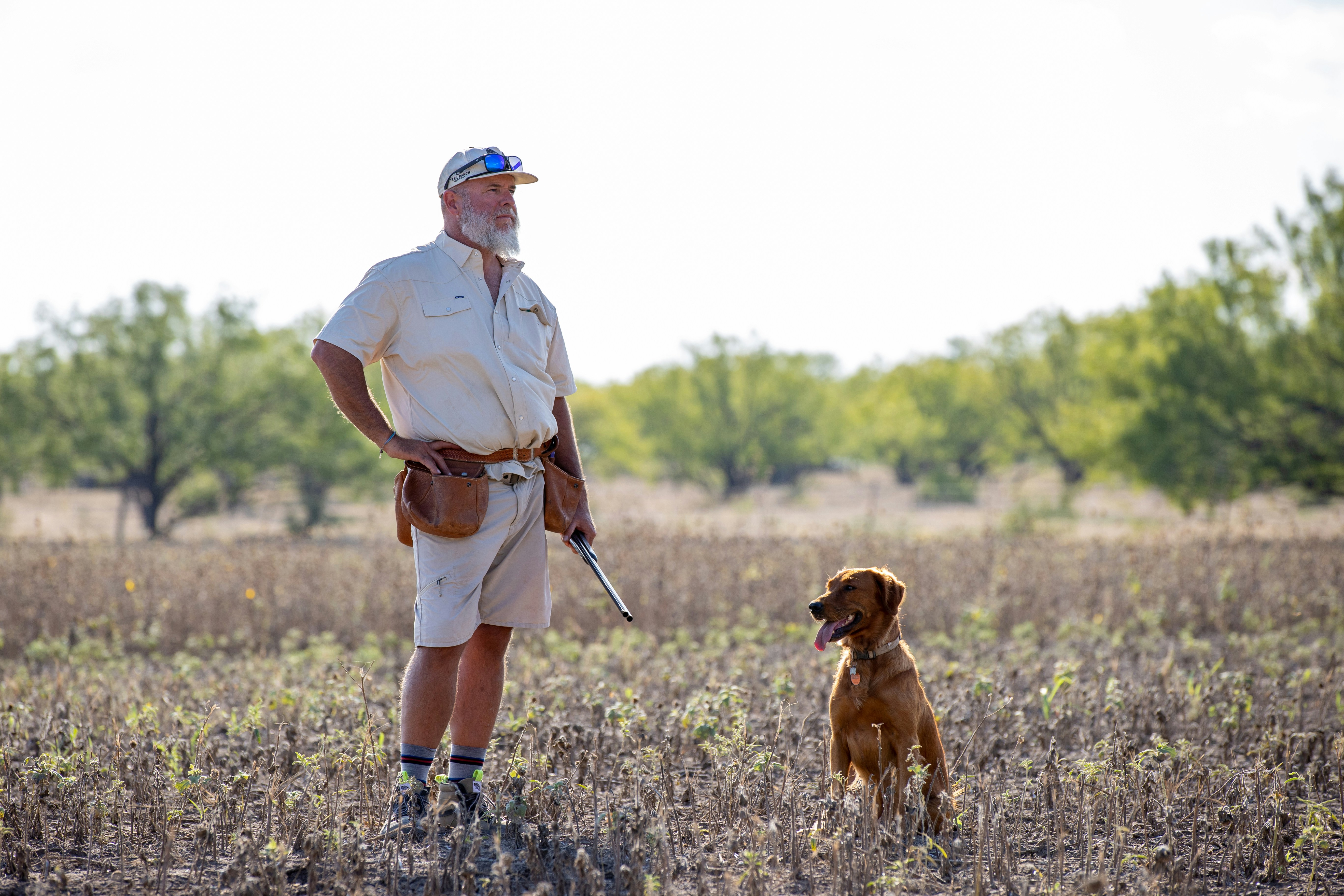 a man with a dog in a field