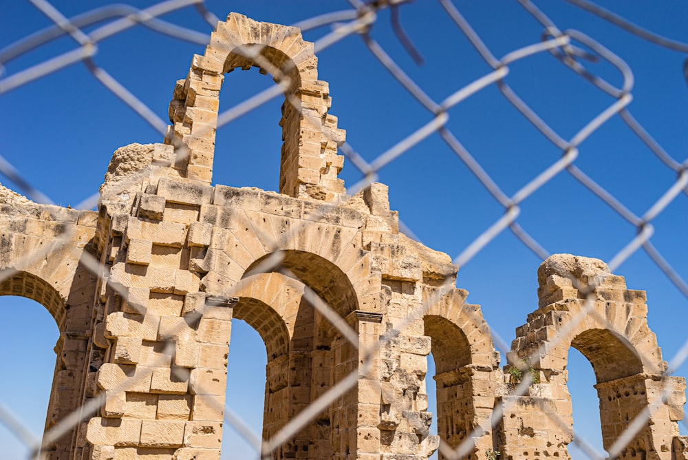 a stone structure with a fence around it