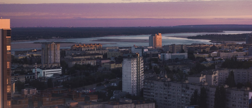 a city with a body of water in the background