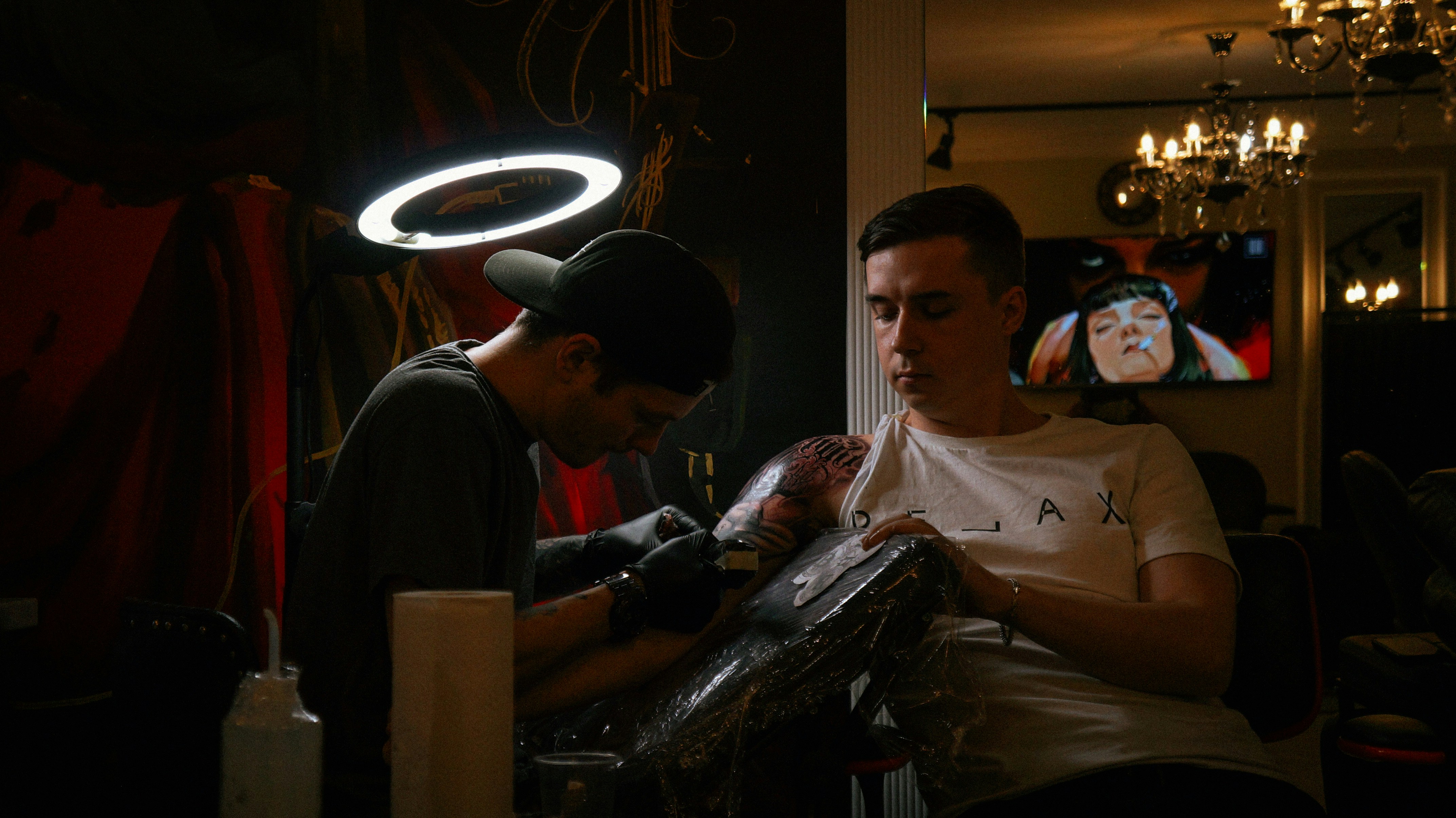 a man sitting at a table with another man sitting at a table