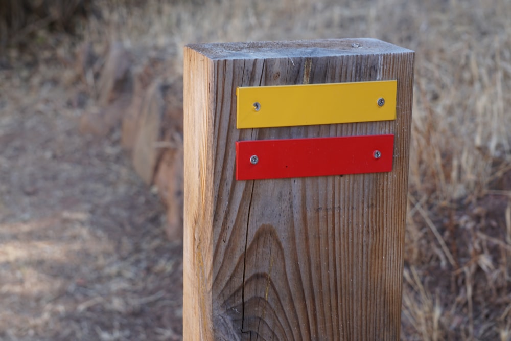 a wood post with a red and yellow square on it