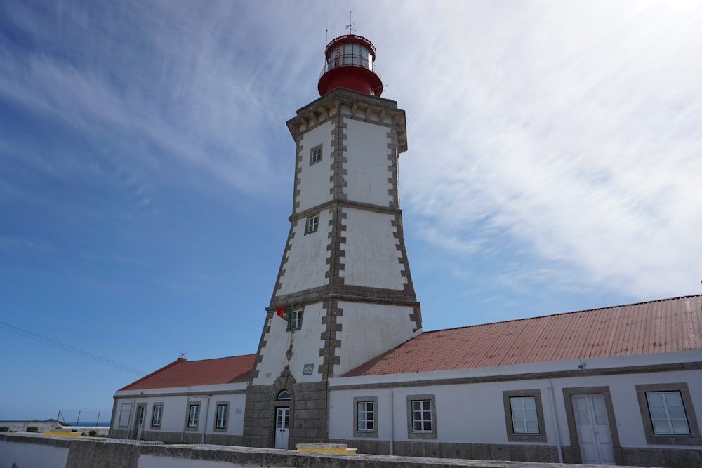 a white tower with a red top