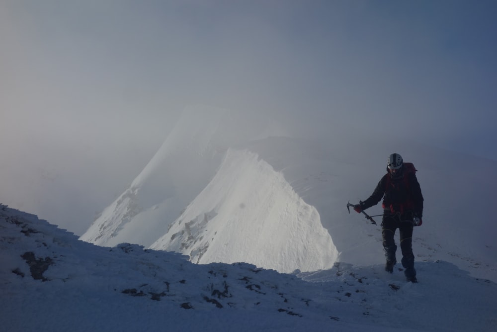 a person hiking up a snowy mountain