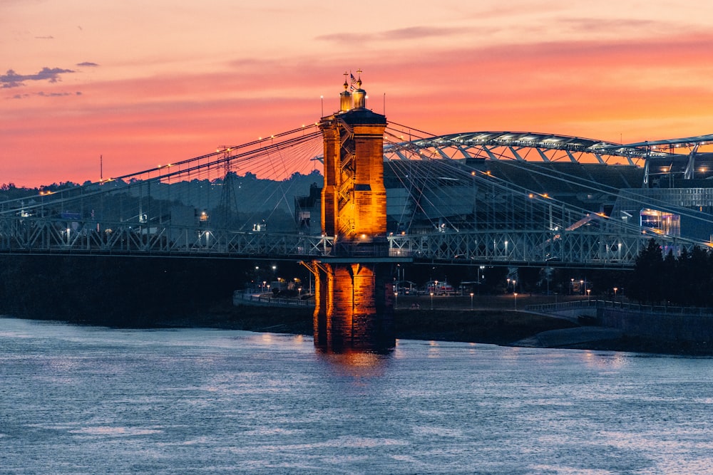 a bridge with lights at sunset