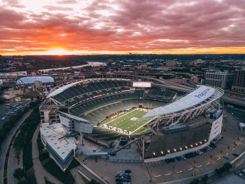 a large stadium with a sunset in the background
