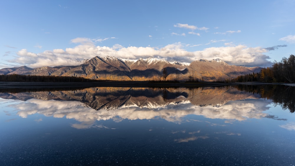 a body of water with mountains in the background