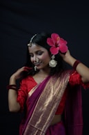 a woman wearing a red dress and a pink flower crown