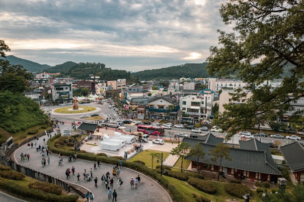 A vibrant cityscape showing diverse people using eco-friendly transportation and green public spaces.