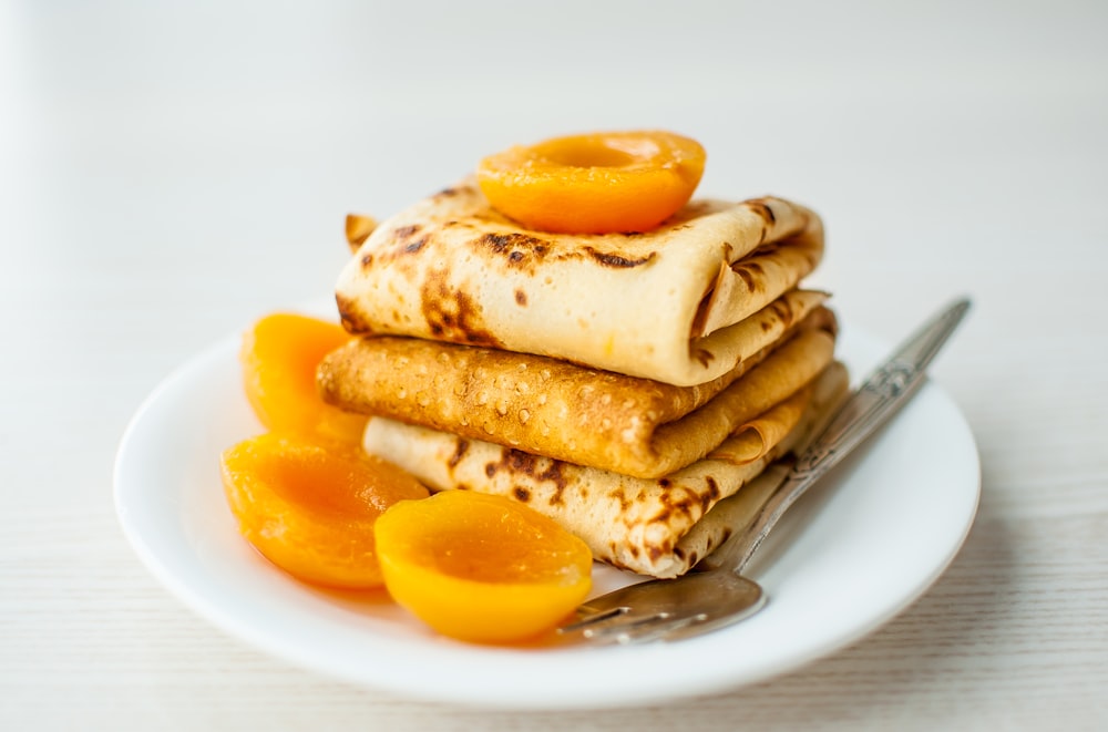 a plate of waffles and oranges