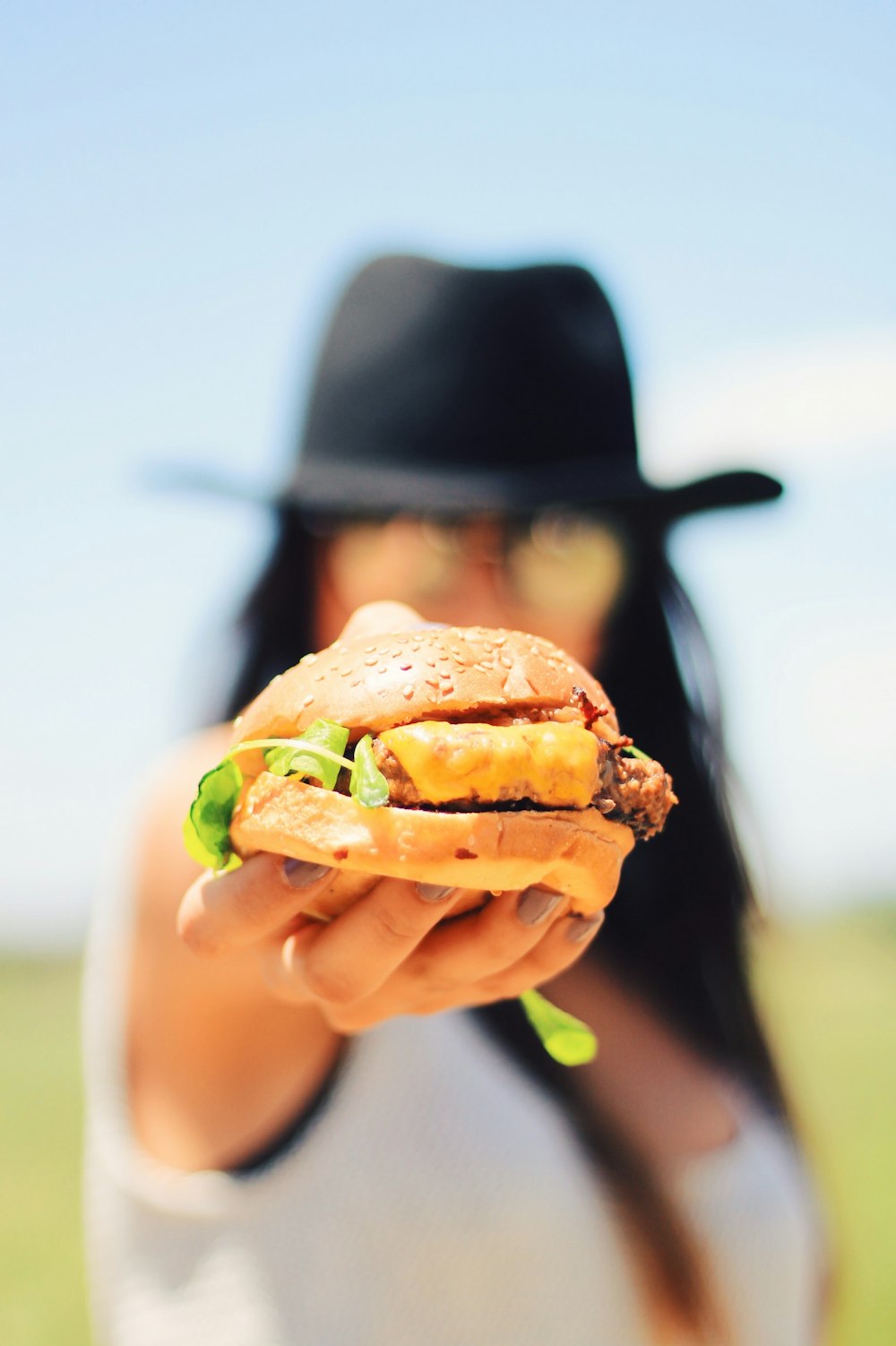 a person holding a burger