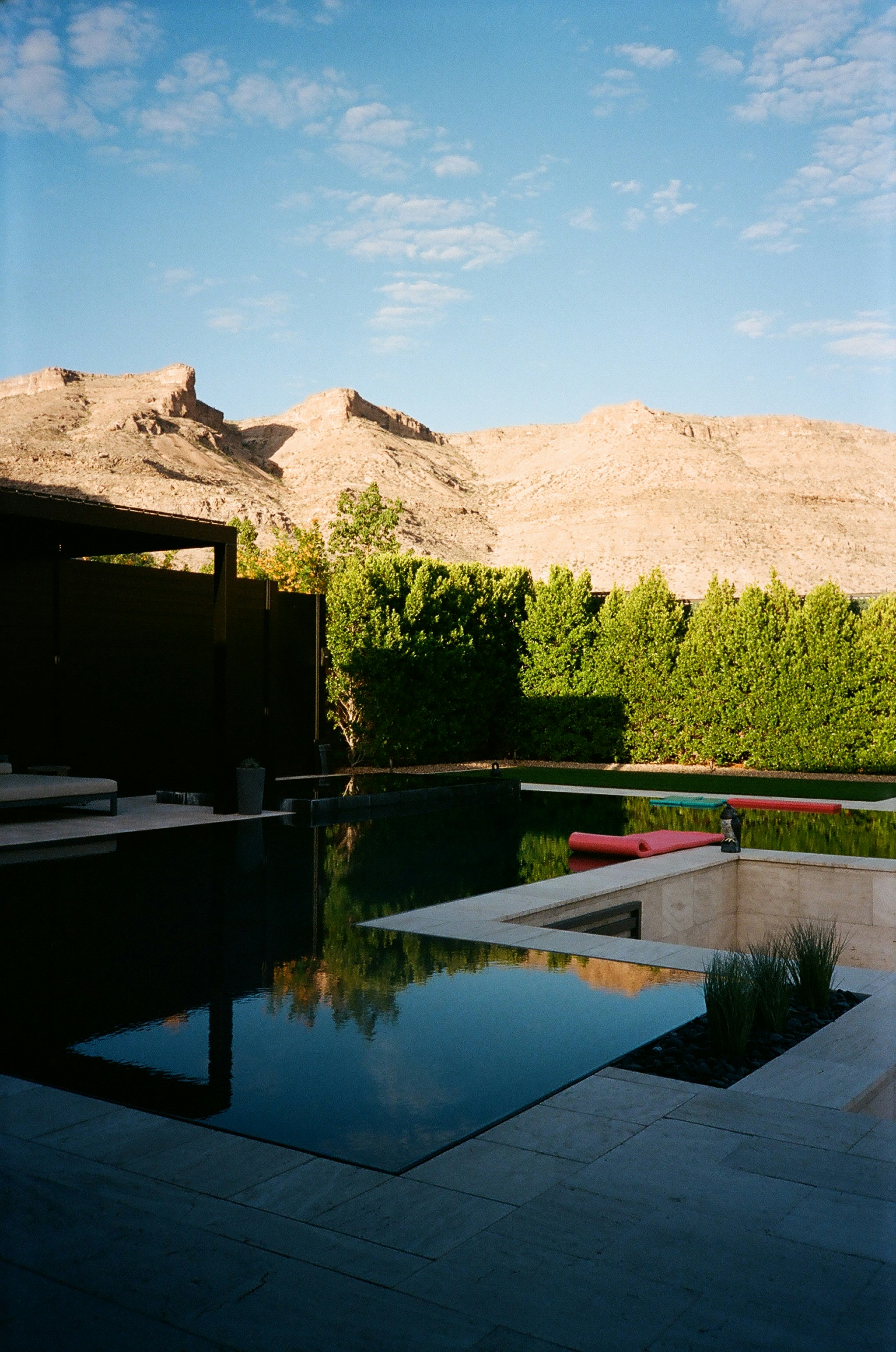 a pool with a mountain in the background