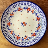 Close-up of a ceramic plate with a colorful, detailed floral print.