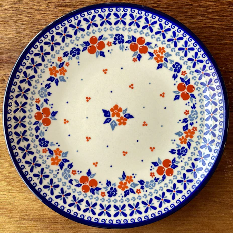 Close-up of a colorful ceramic plate with swirling patterns of orange and blue.
