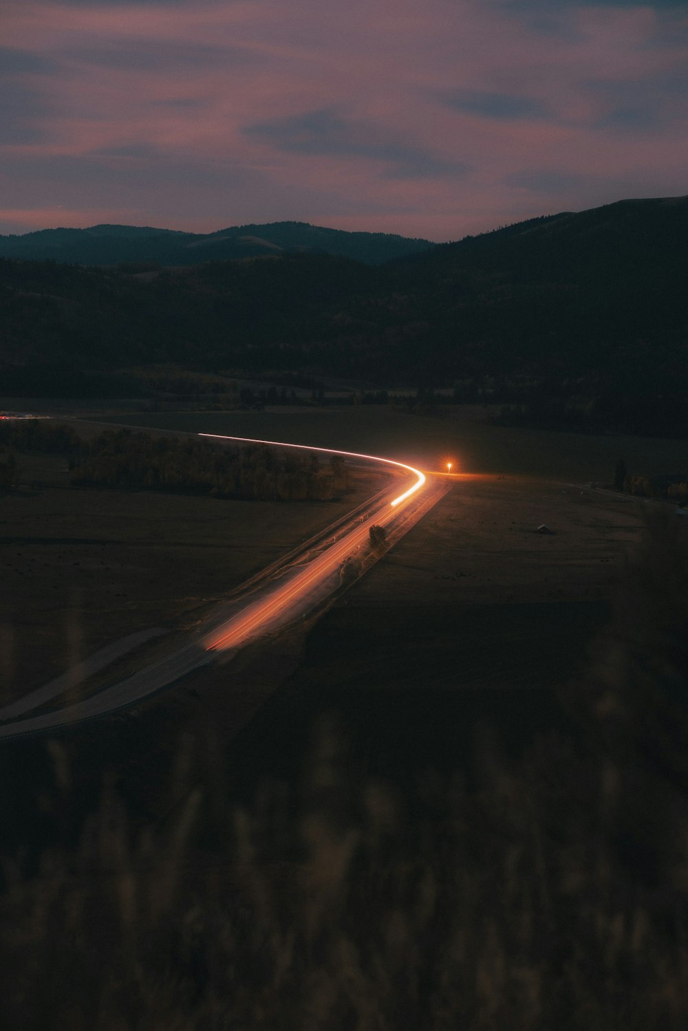 a road with a sunset in the background