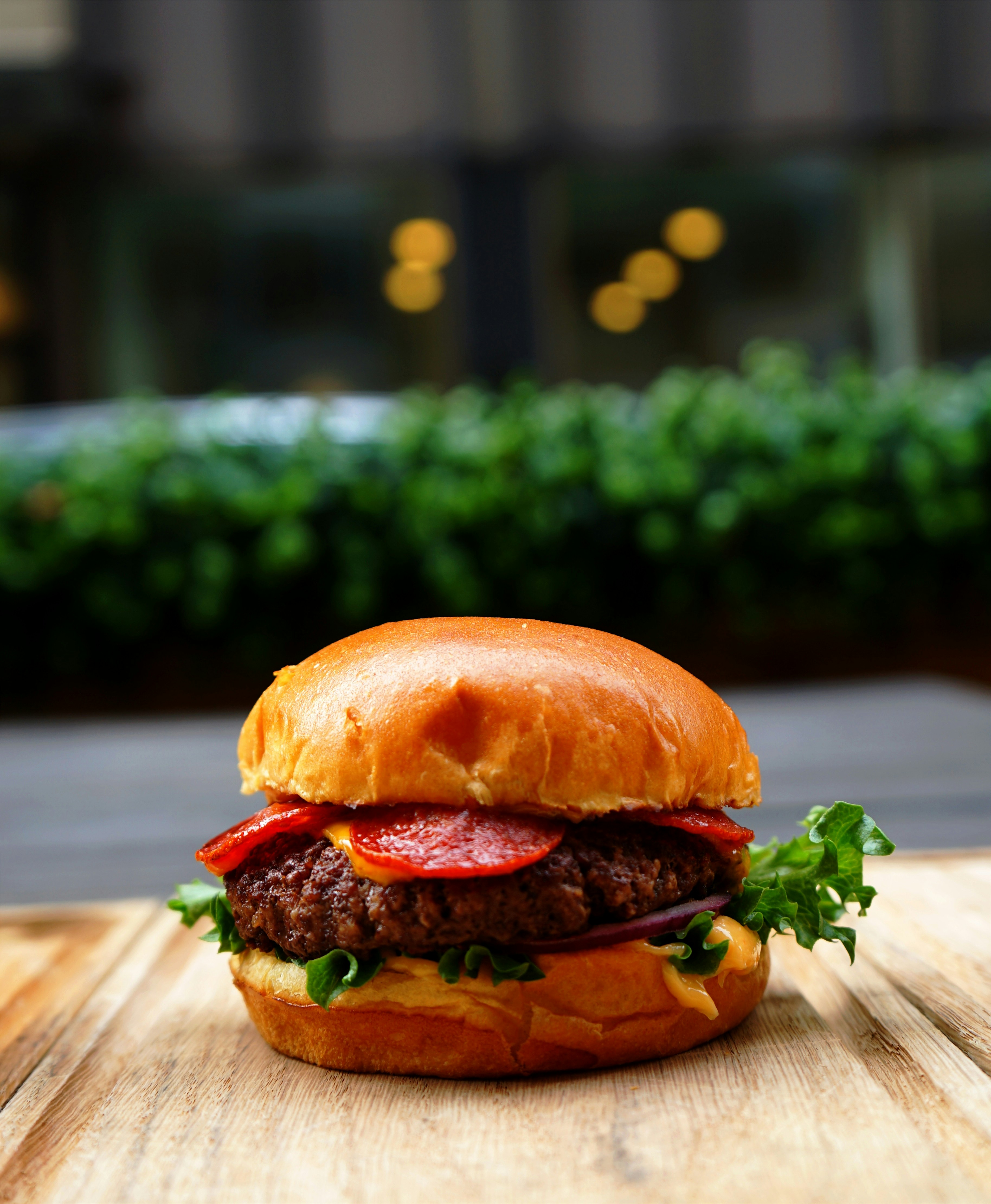 a cheeseburger on a wooden surface