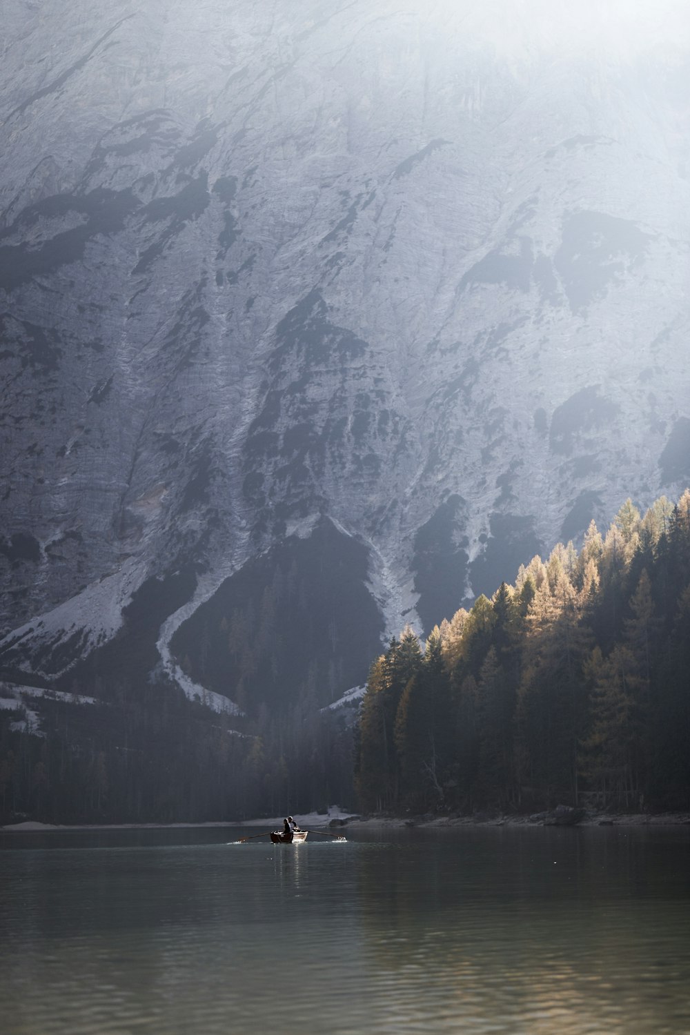 a body of water with mountains in the back