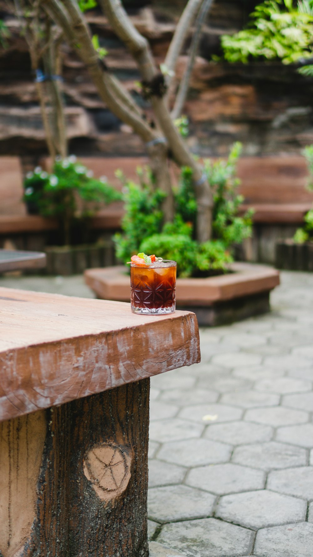 a glass of liquid on a wooden table