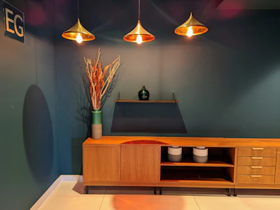 Sideboard buffet with decorative items and warm pendant lights overhead.