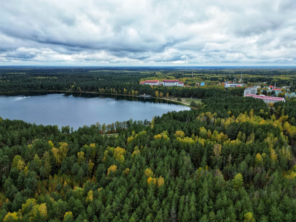 a lake surrounded by trees and a building