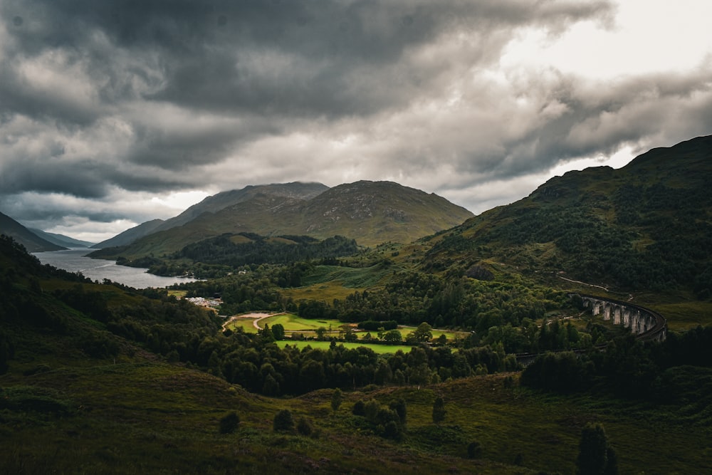 a landscape with hills and a body of water in the distance