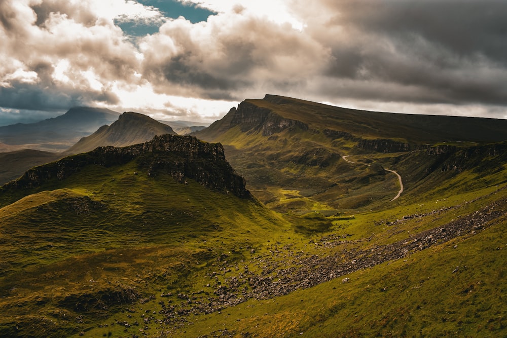 a valley with mountains in the background