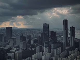 a city skyline with clouds in the sky