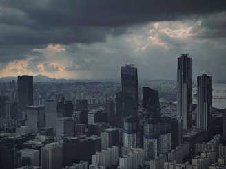 a city skyline with clouds in the sky
