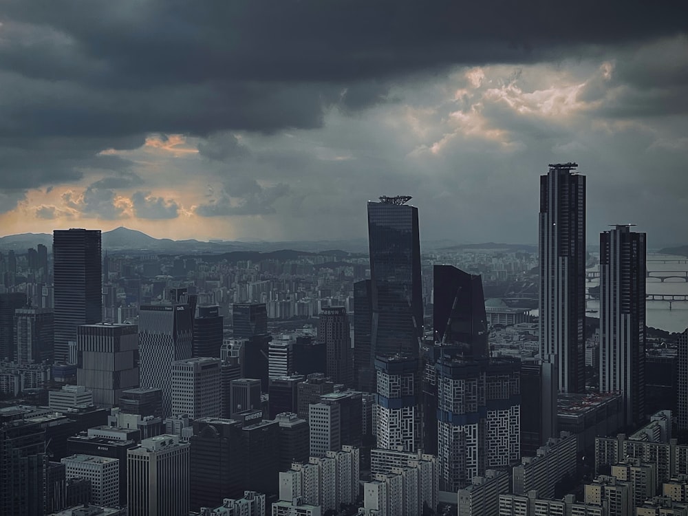 a city skyline with clouds in the sky