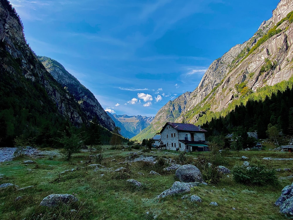 a house in a valley between mountains