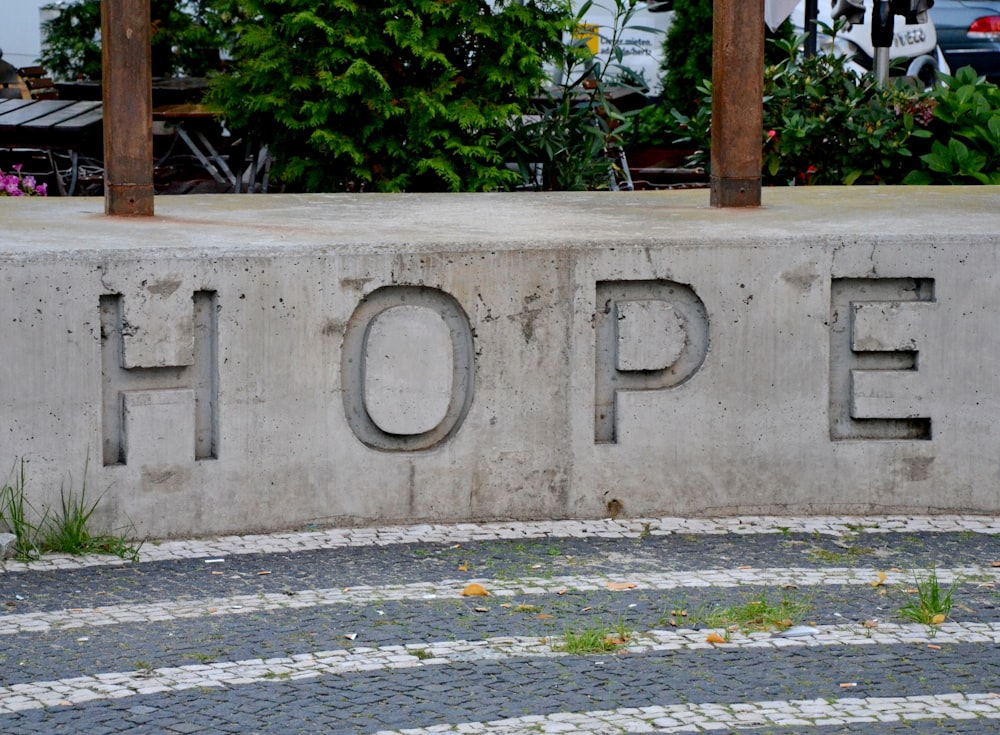 a concrete wall with a sign on it