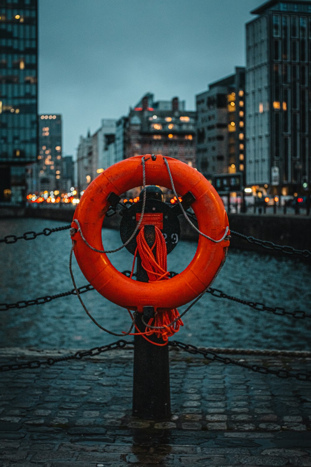 a red life preserver on a chain in a city