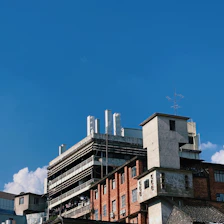 Exterior view of Madhav Industries factory building in Bawana on a clear day showcasing a professional industrial atmosphere.