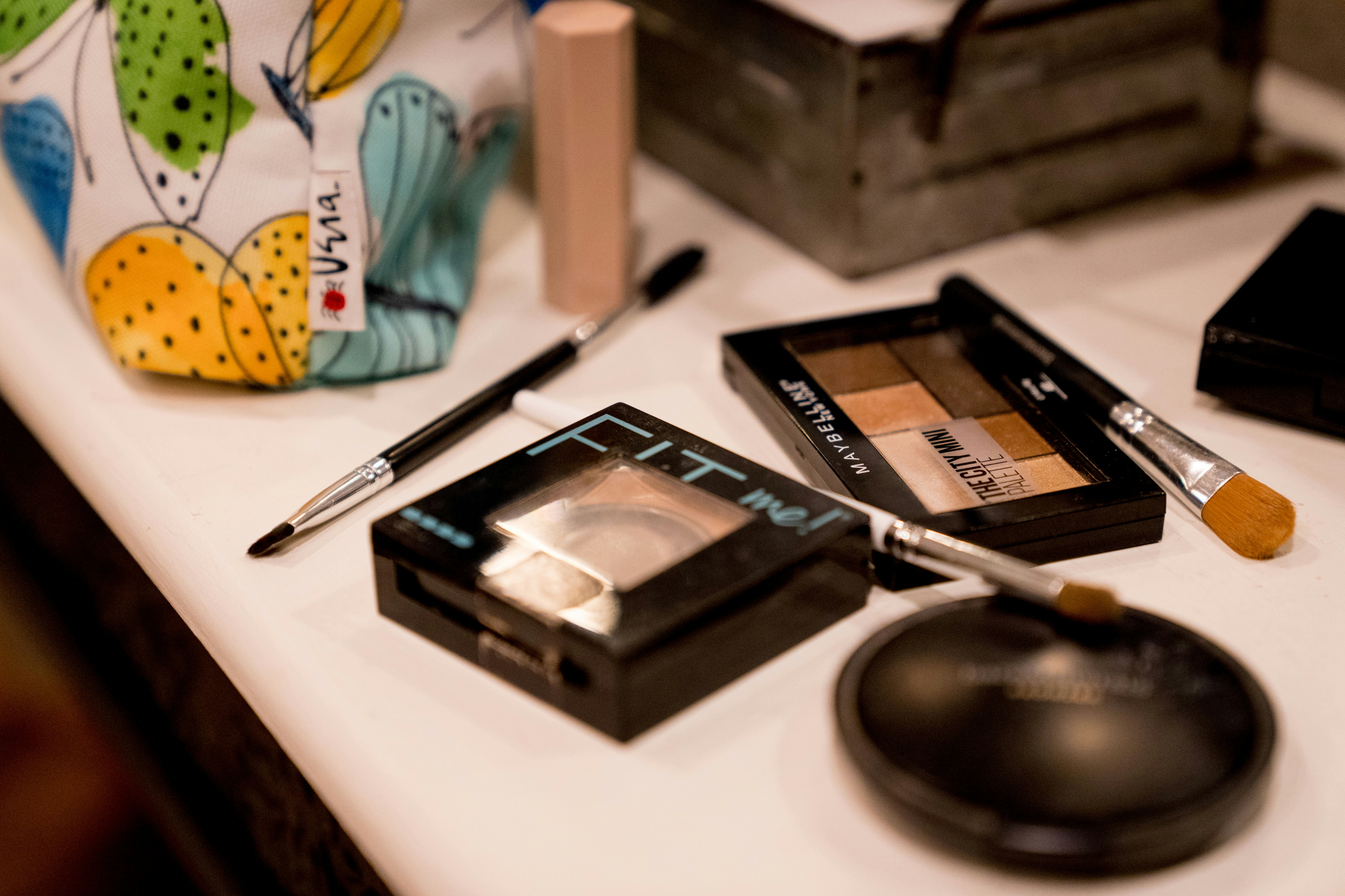Scattered make up and brushes on a table