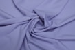 Close-up of soft, elegant lilac fabric folded neatly, highlighting texture and quality.