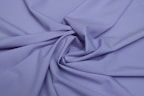 Close-up of soft, elegant lilac fabric folded neatly, highlighting texture and quality.