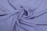 Close-up of a soft, fluffy lilac-colored fabric with gentle folds.