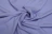 Close-up of a soft, fluffy lilac-colored fabric with gentle folds.