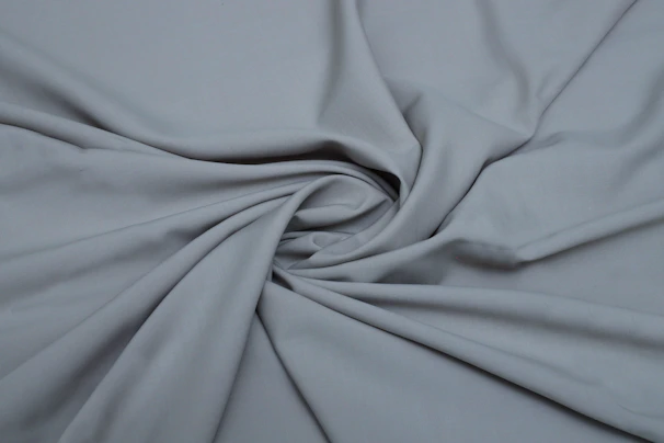 Elegant casual wear featuring soft jersey fabric in slate grey, styled with minimal accessories