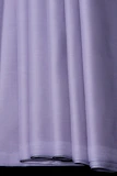 Soft purple silk pajama set folded neatly on a white surface