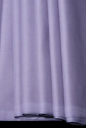 Soft purple silk pajama set folded neatly on a white surface