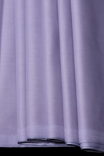 Close-up of a neatly folded purple shirt from Continent Clothing, highlighting the fine fabric texture.