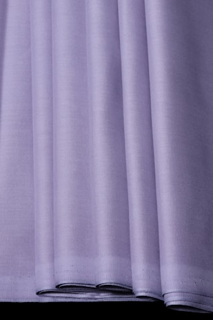 Close-up of a neatly folded purple shirt from Continent Clothing, highlighting the fine fabric texture.