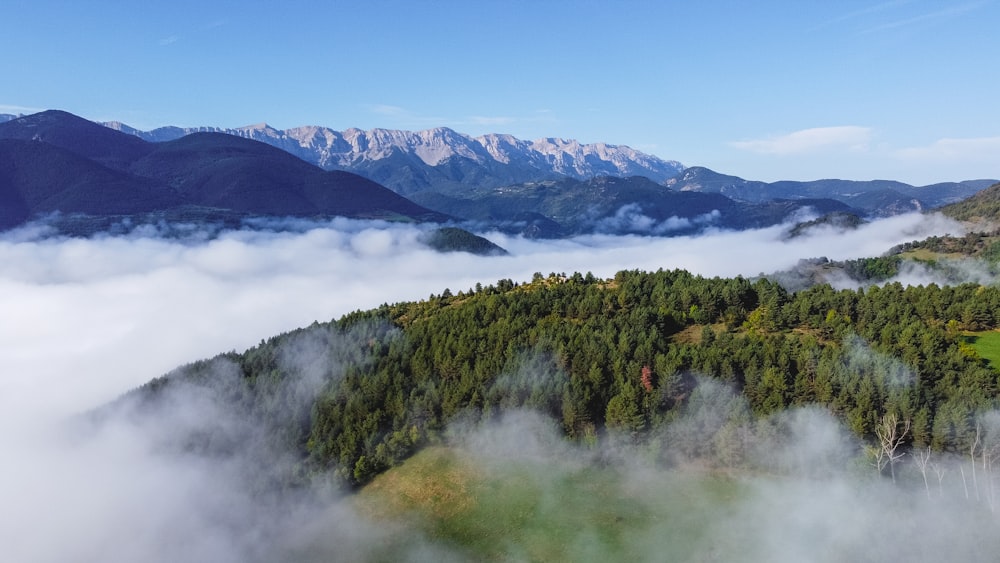 a view of a mountain range and clouds from above