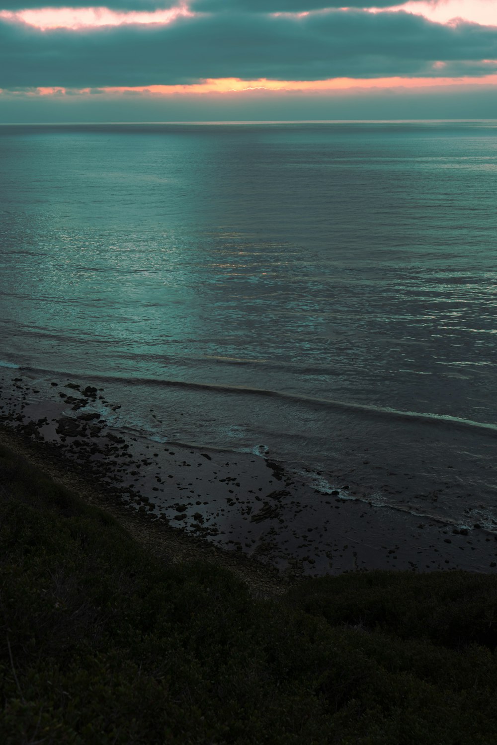 a beach with a body of water in the background